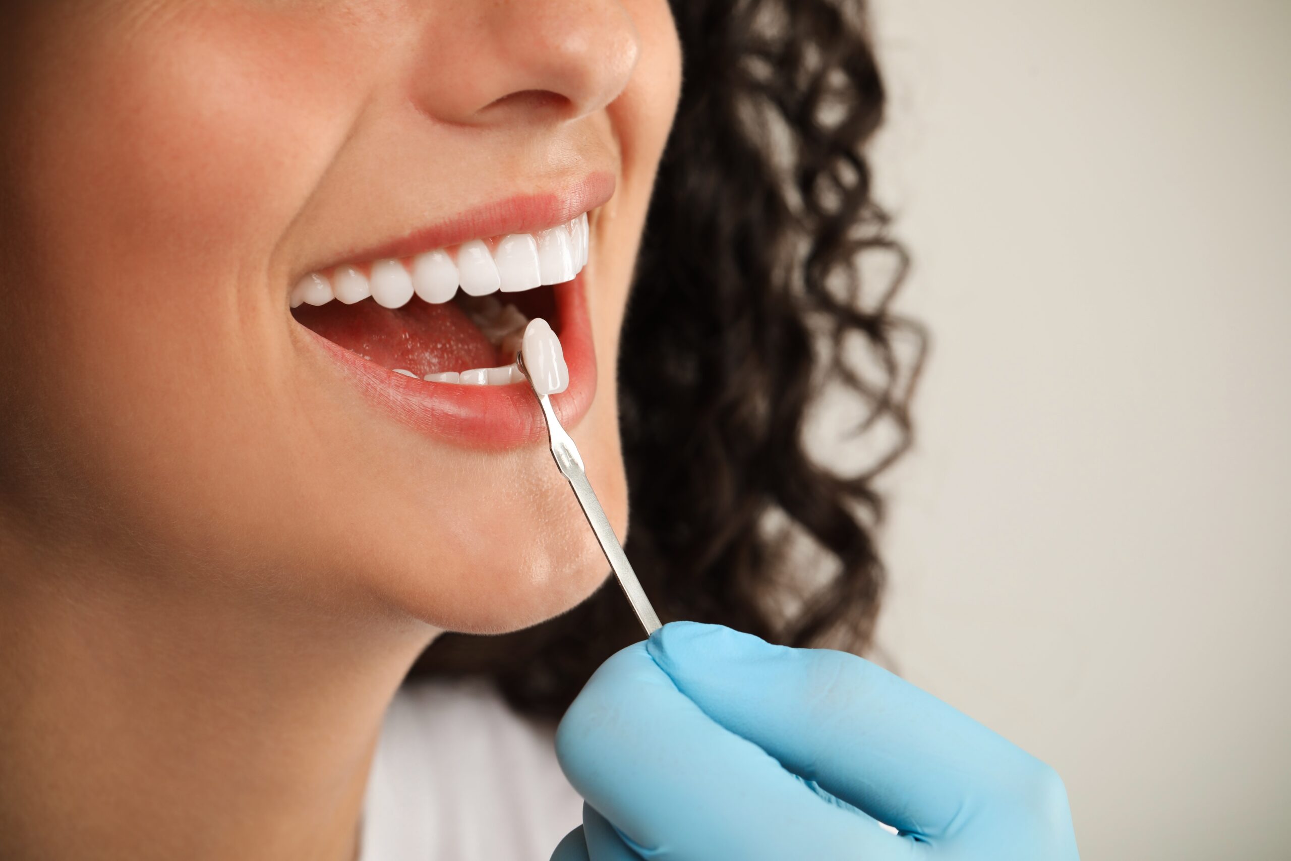 Doctor,Checking,Young,Woman's,Teeth,Color,On,Light,Grey,Background, braces littleton