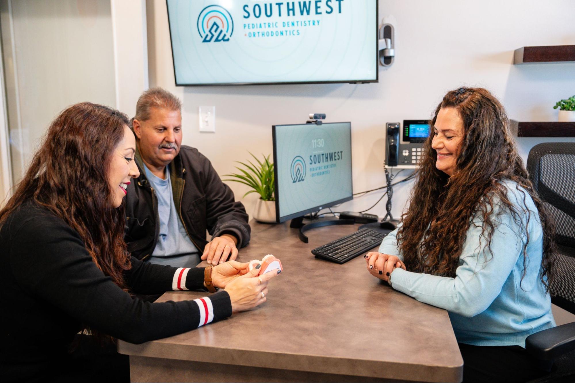 Family consulting with an orthodontic hygienist at our Littleton orthodontic office.
